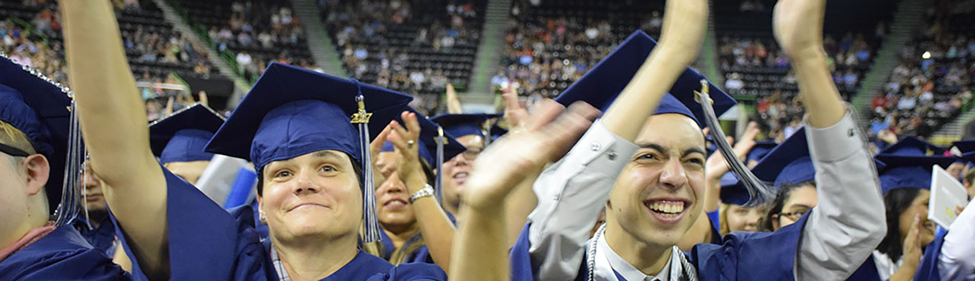 Students celebrate at graduation in their caps and gowns